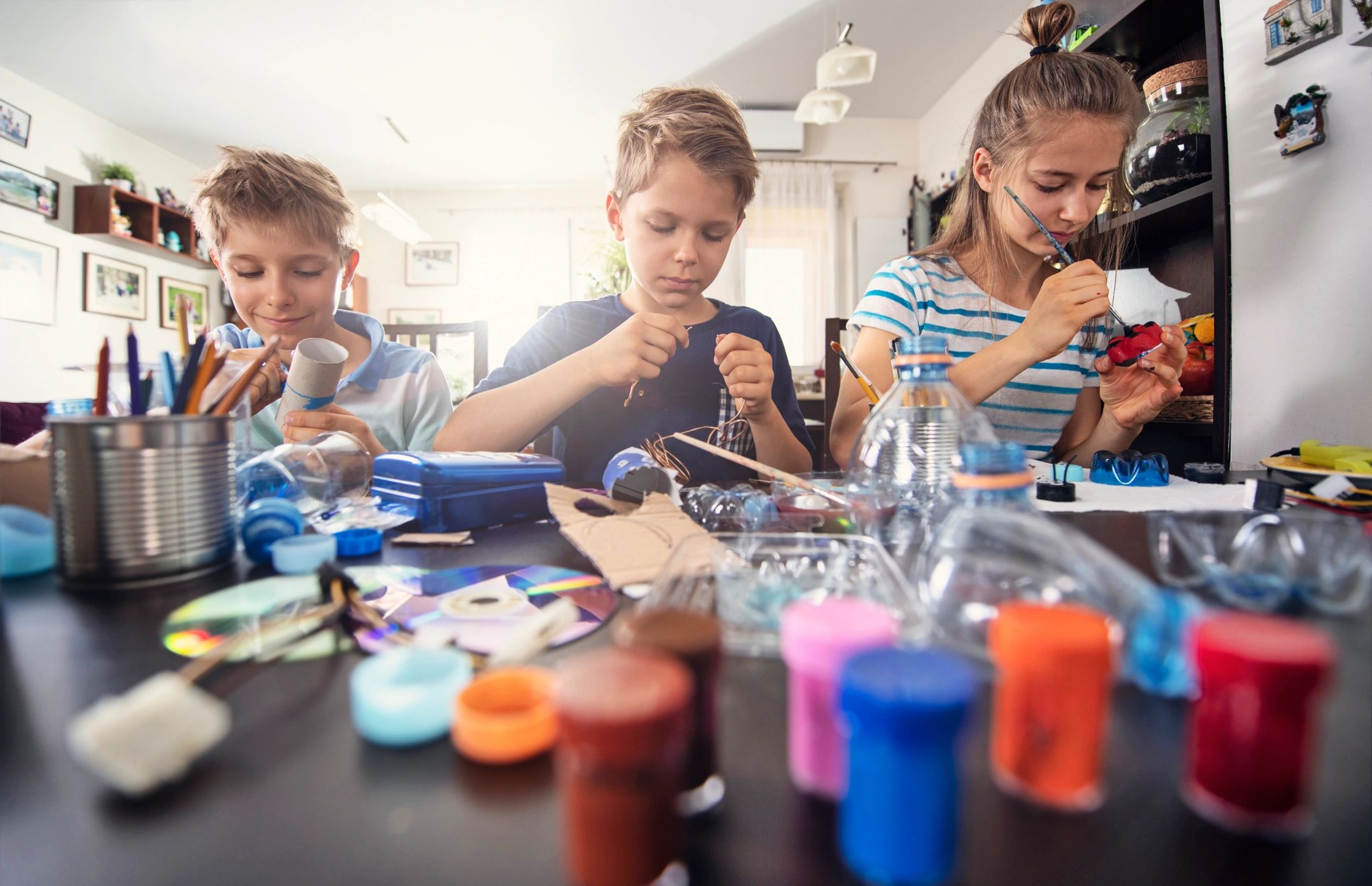 Kids upcycling and sorting materials for a craft project