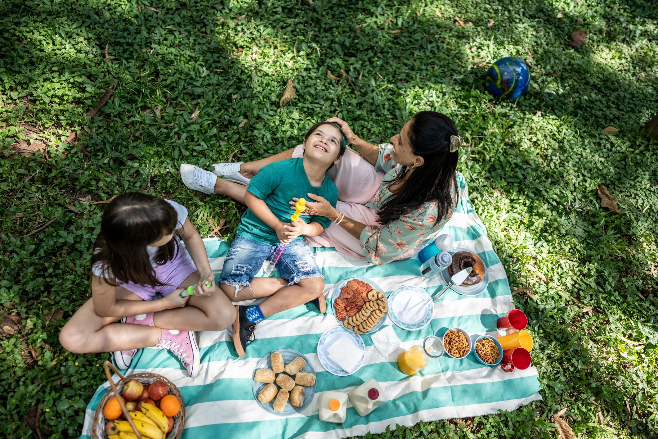 Family picnic on a blanket in a park