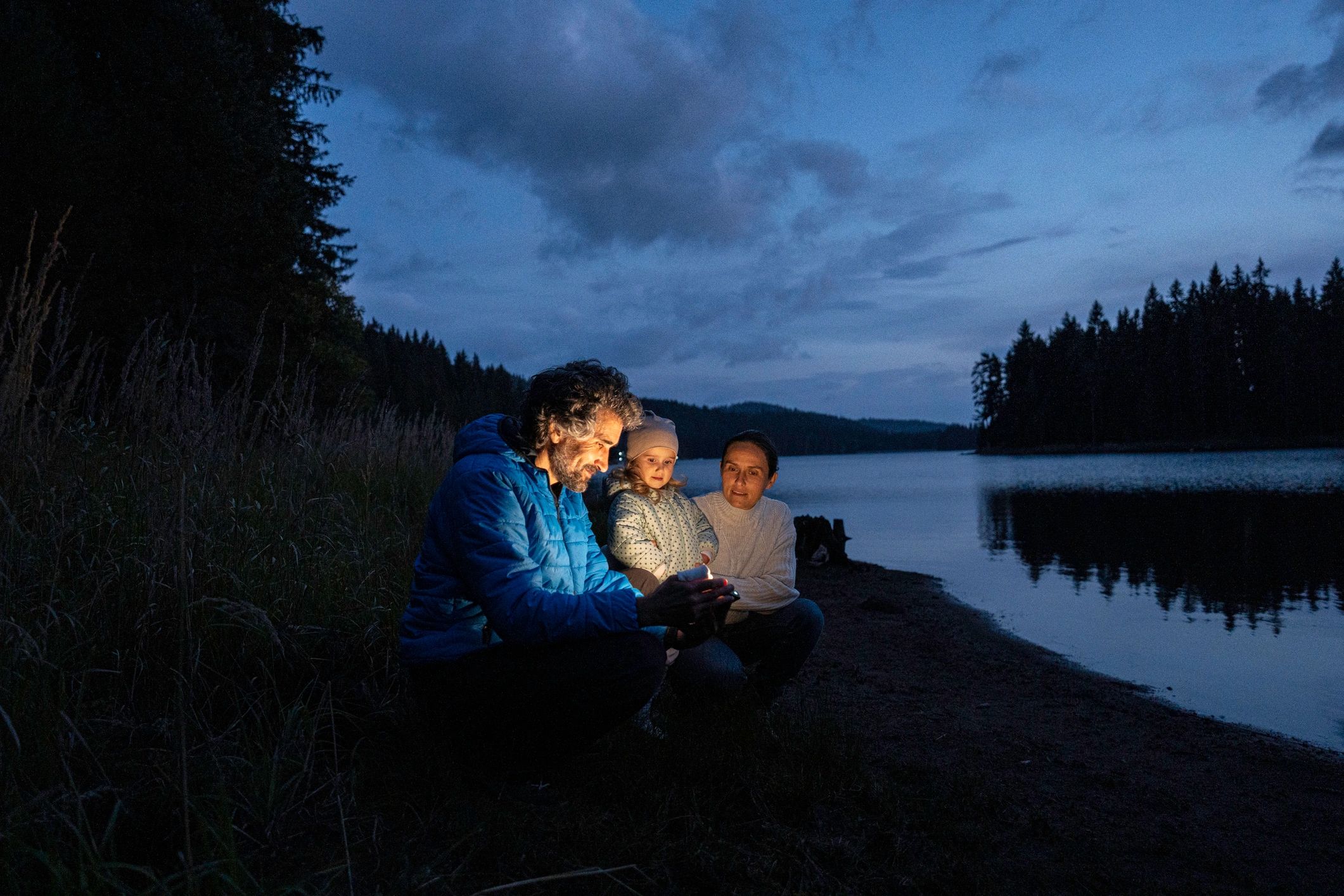 Family spending a calm evening by a lake